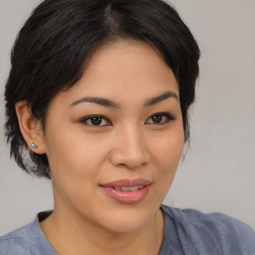 Joyful asian young-adult female with medium  brown hair and brown eyes