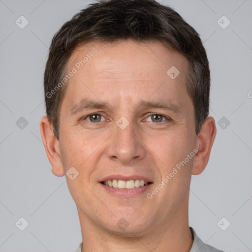 Joyful white adult male with short  brown hair and brown eyes