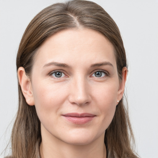 Joyful white young-adult female with long  brown hair and grey eyes