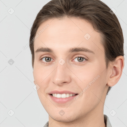 Joyful white young-adult female with short  brown hair and grey eyes