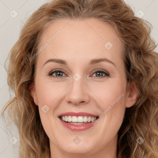 Joyful white young-adult female with long  brown hair and blue eyes