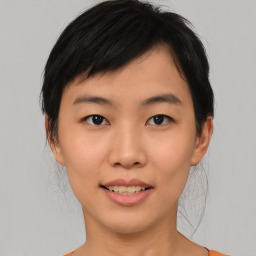 Joyful asian young-adult female with medium  black hair and brown eyes