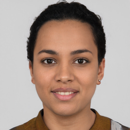 Joyful latino young-adult female with short  black hair and brown eyes