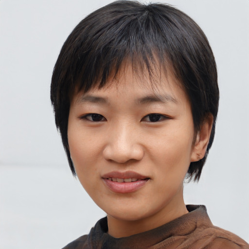 Joyful asian young-adult female with medium  black hair and brown eyes