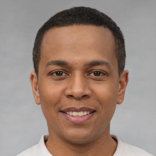 Joyful latino young-adult male with short  black hair and brown eyes