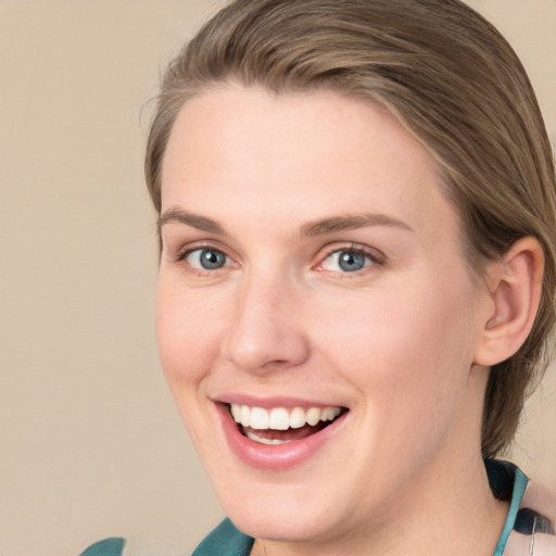 Joyful white young-adult female with medium  brown hair and blue eyes