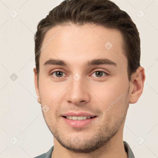 Joyful white young-adult male with short  brown hair and brown eyes