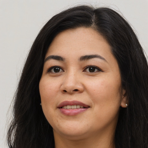 Joyful asian young-adult female with long  brown hair and brown eyes