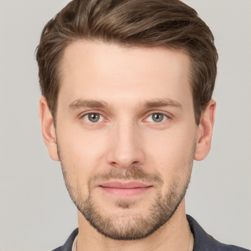 Joyful white young-adult male with short  brown hair and grey eyes