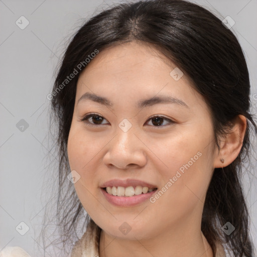 Joyful asian young-adult female with medium  brown hair and brown eyes