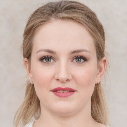 Joyful white young-adult female with medium  brown hair and blue eyes