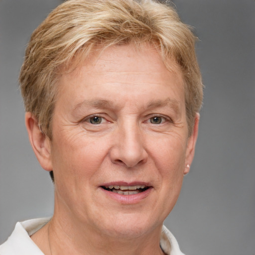 Joyful white middle-aged female with short  brown hair and grey eyes