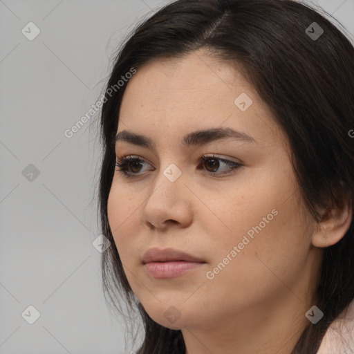 Joyful asian young-adult female with long  brown hair and brown eyes