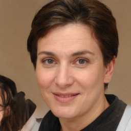 Joyful white adult female with short  brown hair and brown eyes