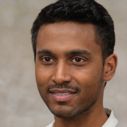 Joyful black young-adult male with short  black hair and brown eyes