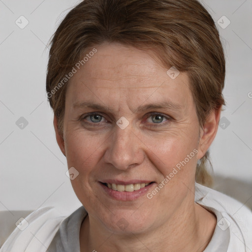 Joyful white adult female with short  brown hair and grey eyes