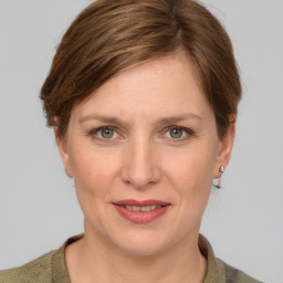 Joyful white adult female with medium  brown hair and grey eyes