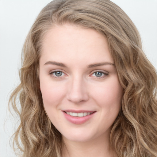 Joyful white young-adult female with long  brown hair and blue eyes