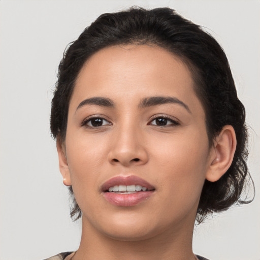 Joyful latino young-adult female with long  brown hair and brown eyes