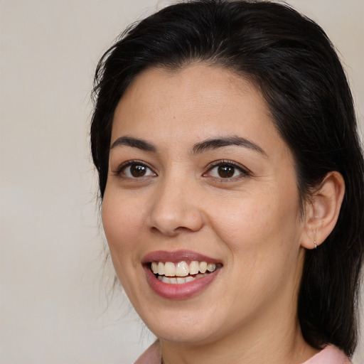 Joyful latino young-adult female with medium  brown hair and brown eyes