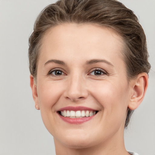 Joyful white young-adult female with short  brown hair and brown eyes