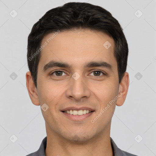 Joyful white young-adult male with short  black hair and brown eyes