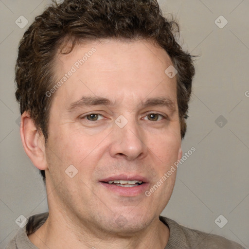 Joyful white adult male with short  brown hair and grey eyes