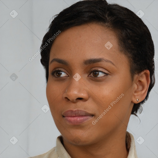 Joyful black young-adult female with short  brown hair and brown eyes