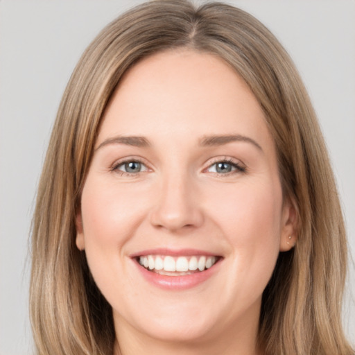 Joyful white young-adult female with long  brown hair and green eyes