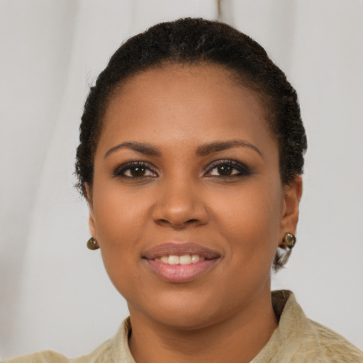 Joyful black young-adult female with short  brown hair and brown eyes