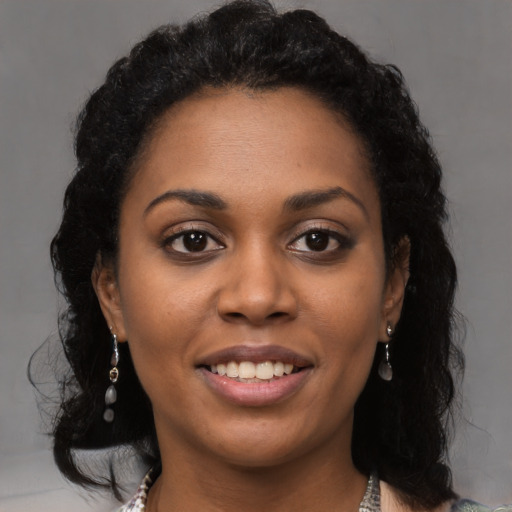 Joyful black young-adult female with medium  brown hair and brown eyes