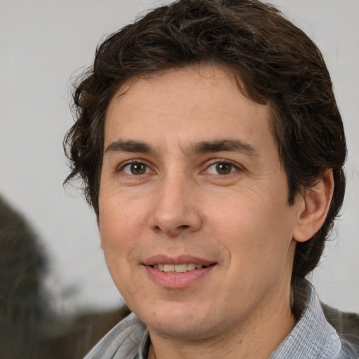 Joyful white adult male with medium  brown hair and brown eyes