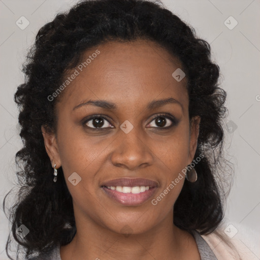 Joyful black young-adult female with long  brown hair and brown eyes