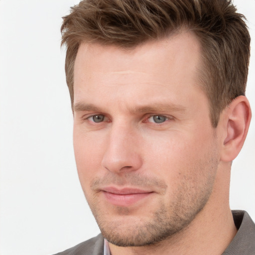 Joyful white adult male with short  brown hair and grey eyes