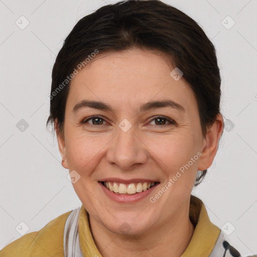 Joyful white adult female with short  brown hair and brown eyes