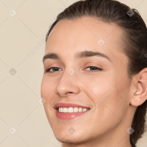 Joyful white young-adult female with long  brown hair and brown eyes