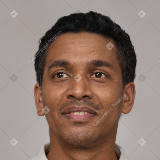 Joyful latino adult male with short  black hair and brown eyes