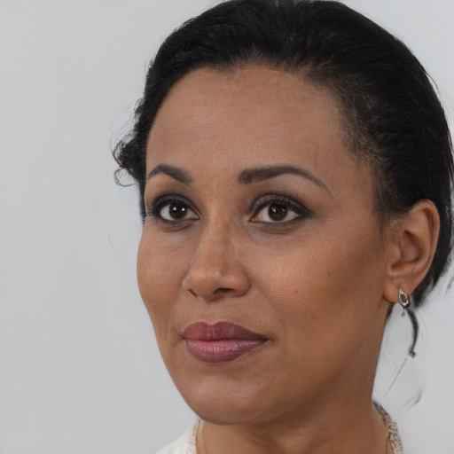 Joyful black young-adult female with medium  brown hair and brown eyes