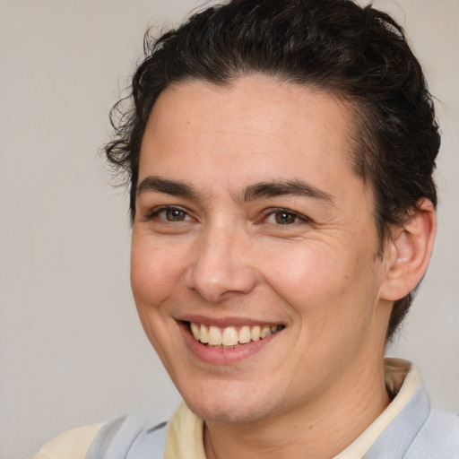 Joyful white young-adult male with medium  brown hair and brown eyes