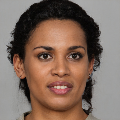 Joyful black young-adult female with medium  brown hair and brown eyes