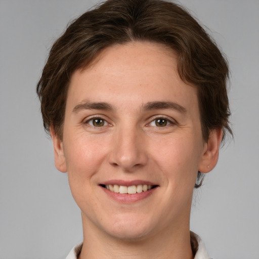 Joyful white young-adult female with short  brown hair and grey eyes