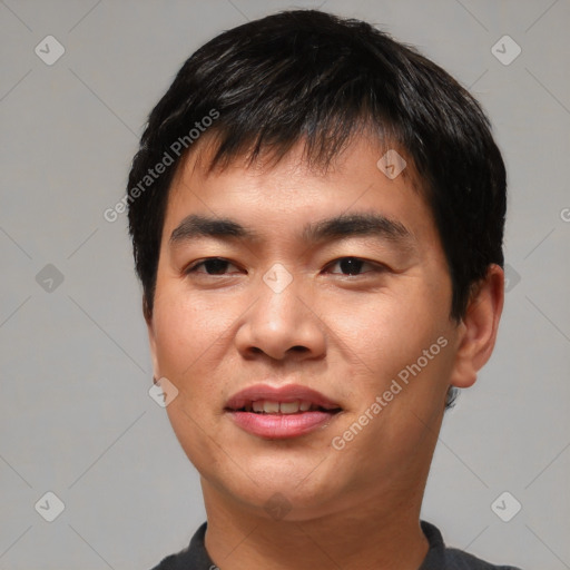 Joyful asian young-adult male with short  black hair and brown eyes