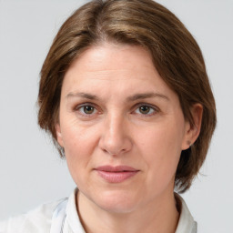 Joyful white adult female with medium  brown hair and grey eyes