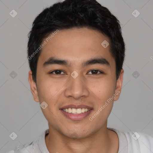 Joyful latino young-adult male with short  black hair and brown eyes