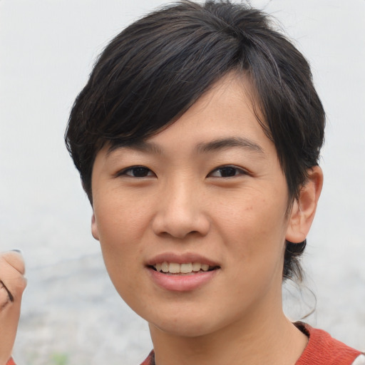 Joyful asian young-adult female with short  brown hair and brown eyes