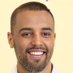 Joyful black young-adult male with short  brown hair and brown eyes