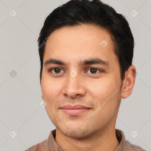 Joyful white young-adult male with short  black hair and brown eyes