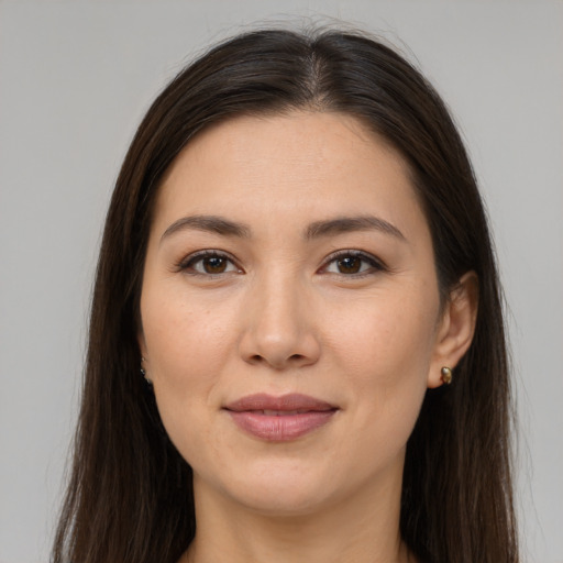 Joyful white young-adult female with long  brown hair and brown eyes