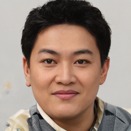 Joyful asian young-adult male with short  black hair and brown eyes