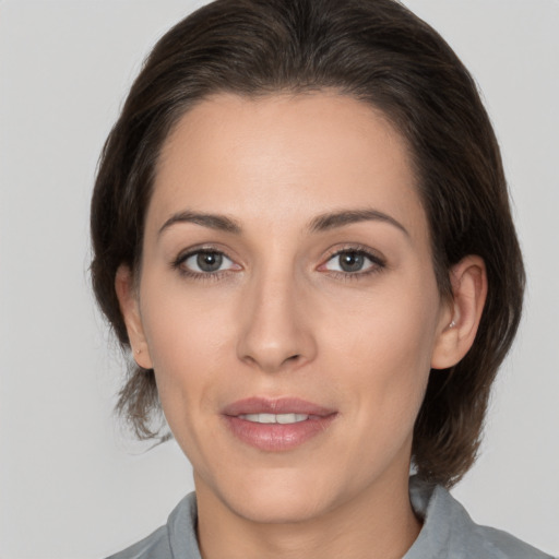 Joyful white adult female with medium  brown hair and brown eyes